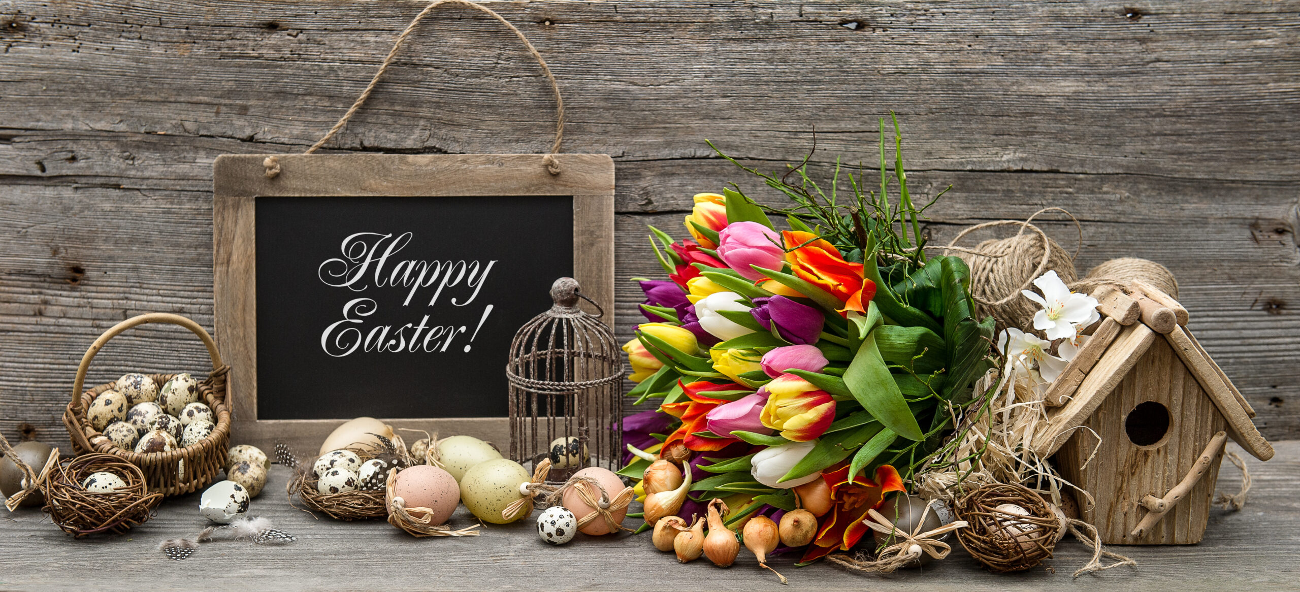 easter decoration with eggs and tulip flowers. vintage style background with sample text Happy Easter!